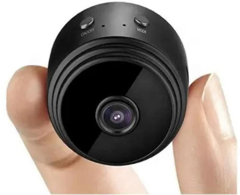 Compact mini camera held between fingers showing small size